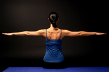 woman stretching out arms: pilates instructor harpenden