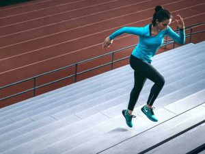 Woman training at running track after acupuncture for athletes 