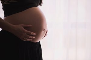 Pregnant woman holding bump
