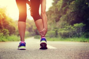Runner with injured lower leg knee physiotherapy harpenden